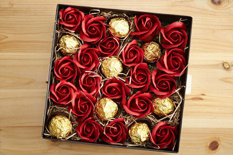 Open box with red roses and chocolates inside