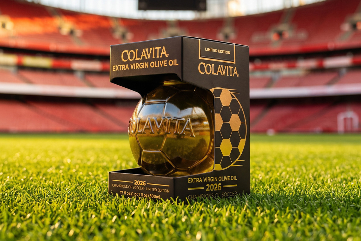 Colavita extra virgin olive oil bottle shaped like a football in its special black and gold packaging by Packly, positioned on the green grass inside a stadium.